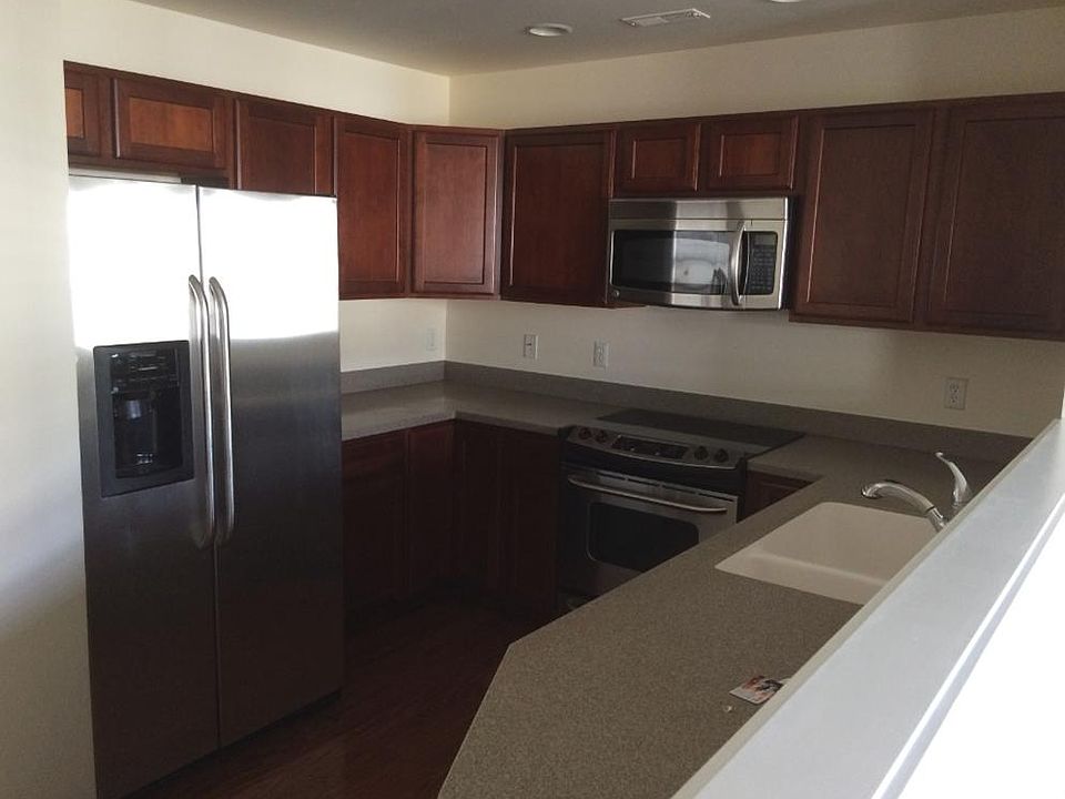 Modern kitchen with stainless steel appliances and recess li