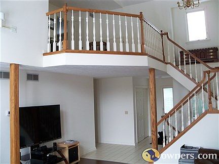 Cathedrals in living room w\beautiful stairs to 2nd floor