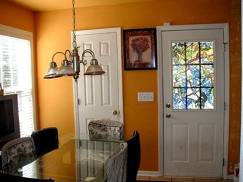 Bright Breakfast Room with side door to side porch