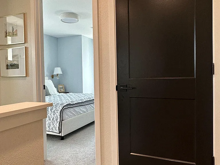 Carpeted stairs leading to top floor and convenient washer/dryer access