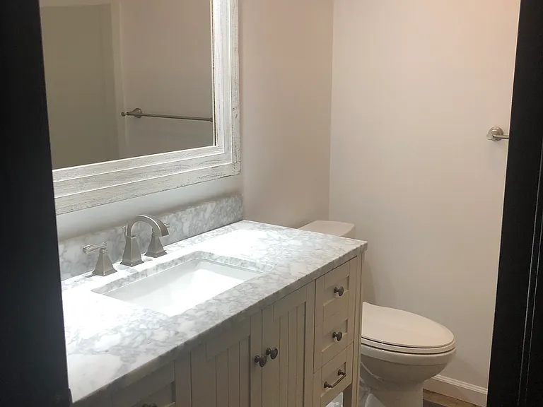 Upstairs bathroom with tub with shower.