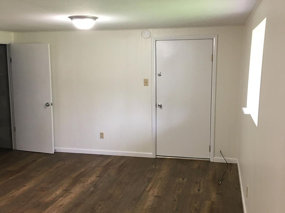 Downstairs Living Room - Left door to Laundry/Utility/Storage Room, Right door to Garage