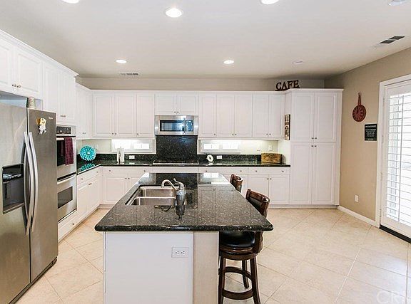 Kitchen has granite counter tops, full backsplash above range, new microwave. New ss refrigerator an