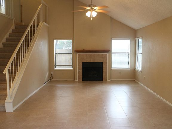 Tile floors throughout main level. Large open living room with vaulted ceiling.