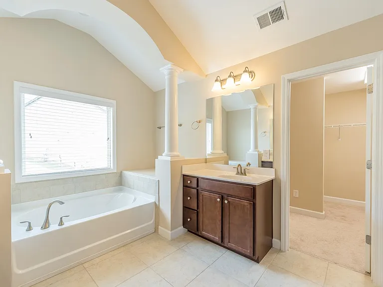 Master Bath with large garden tub and 2 single vanities on either side