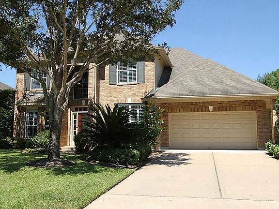Meticulous landscaping adds to the beauty of this home. The porte cochere at the garage adds even mo