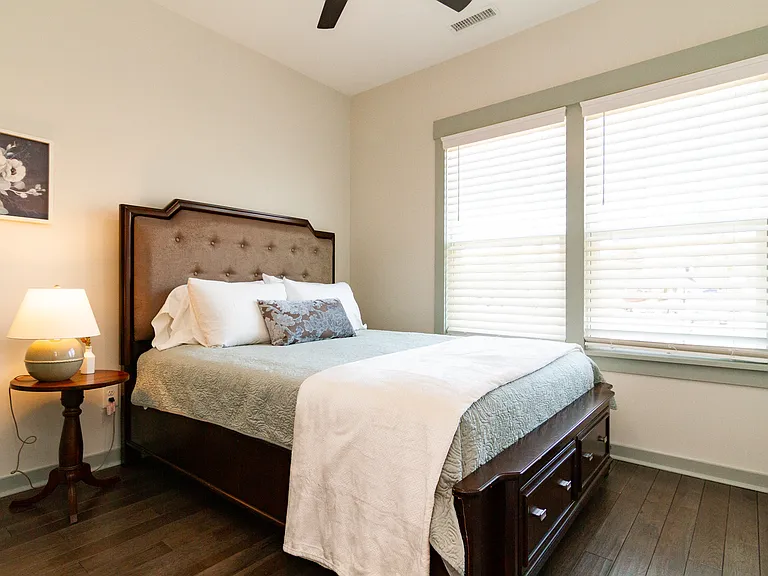 Guest Bedroom with queen size bed. Overlooks a green space, the senior community center, and a couple local restaurants.