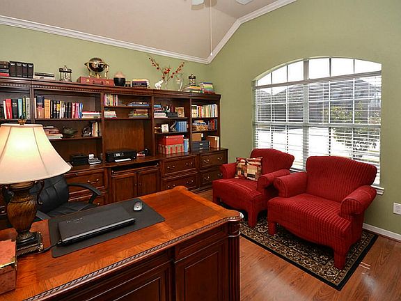High ceilings and arched window accent the study.