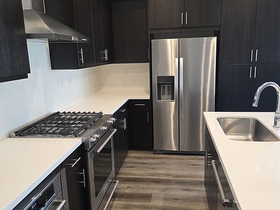 Kitchen with Gas Range and stainless Steel appliances.