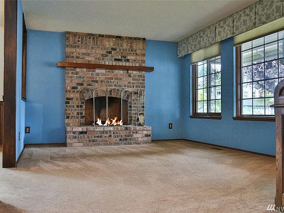 Wide open living room with brick fireplace