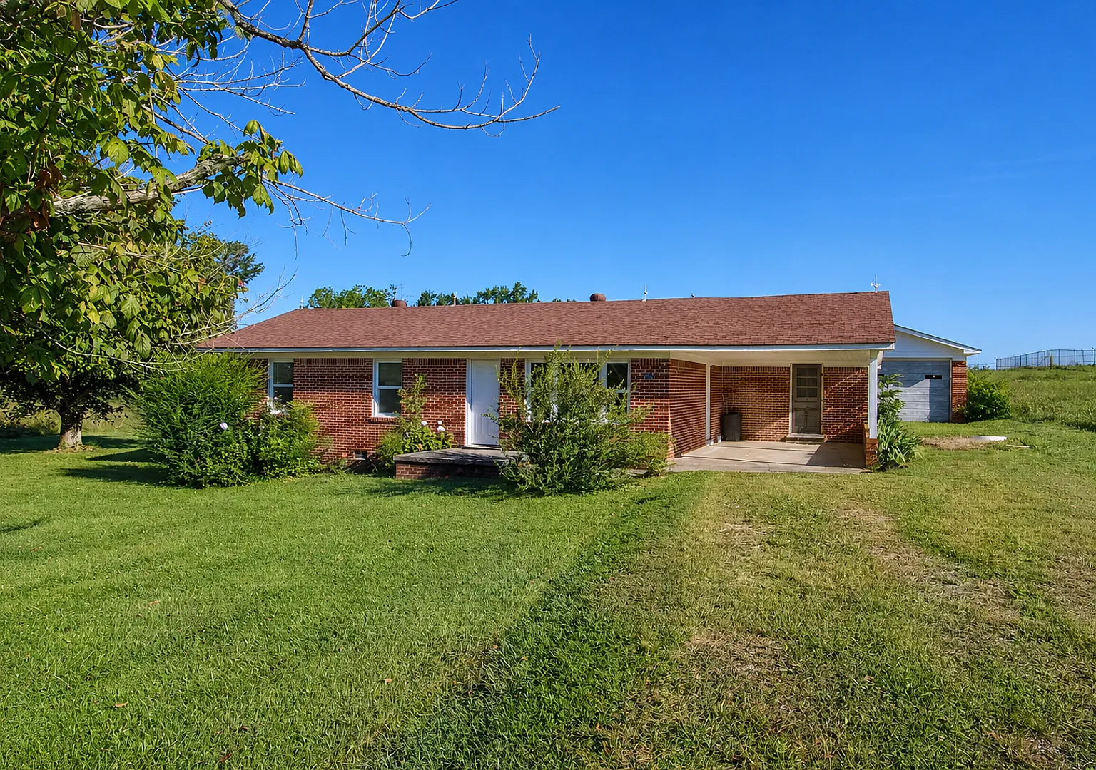 Updated 3-Bedroom Home with Covered Porch and Detached Garage in Baxter — Photo 1