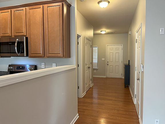 Downstairs hallway with half bath, closet, and access to the garage