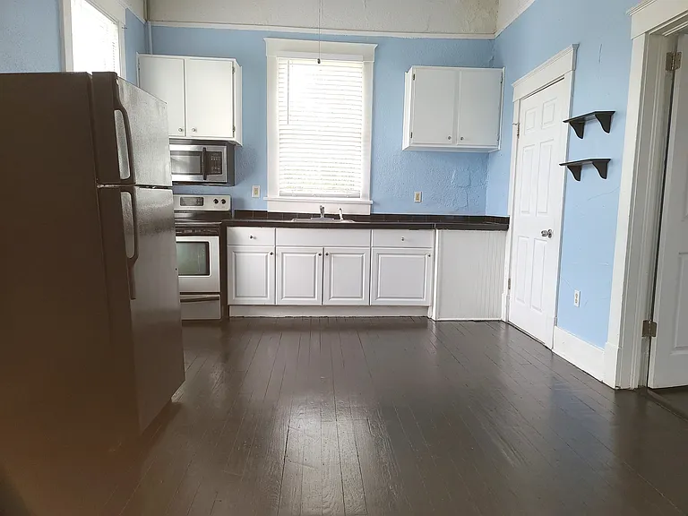 Huge kitchen with fridge, stove & microwave. 
No dishwasher