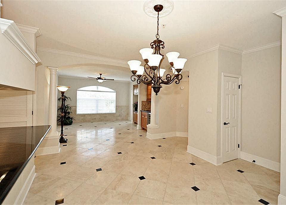 Custom designed Ivory Classic travertine floors w/Black Galaxy granite inserts