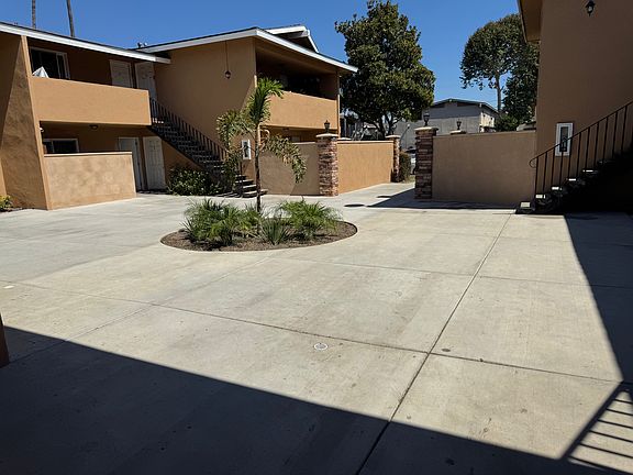 Courtyard area. New concrete February 2025. Palm trees and plants planted all around courtyard area.