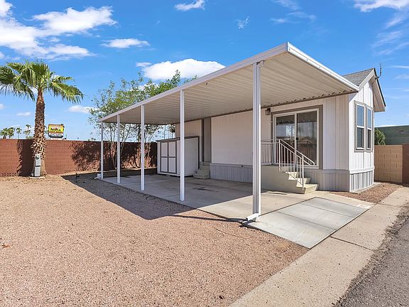 Side of the house with shed that has washer and dryer hookups