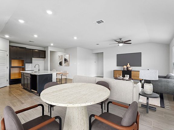 Virtually staged dining and living room in the Preston floorplan at a Meritage Homes community.