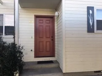 front entrance (door is now blue:) - covered parking directly in front of entry. Additional parking in lot as well as street parking