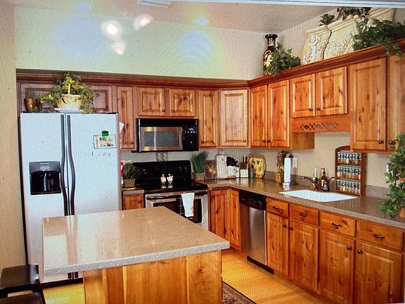 This model townhome has tons of upgrades: Knotty Alder cabinets, with crown molding, solid surface counter tops, stainless steel appliances & Hardwood Flooring.