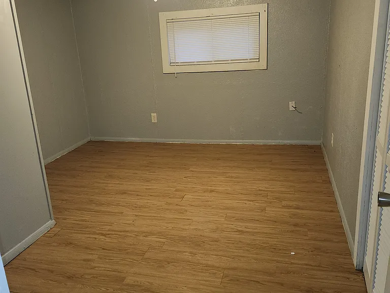 This is a photo of one of the four bedrooms. AI would not allow an upload of the second bedroom because the colors and setup are the same. The floors were recently installed.
