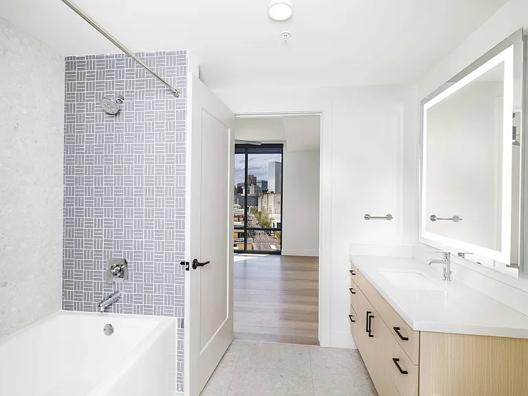 Step into luxury at Modera Golden Triangle. Discover designer bathrooms featuring quartz countertops and backlit mirrors, complemented by serene spa-like soaking tubs for your ultimate relaxation.