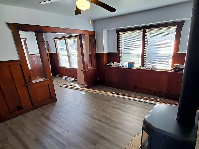 Natural gas stove in dining room, looking through room divider into living room.