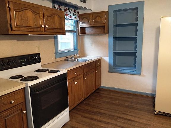 Kitchen with range and refrigerator