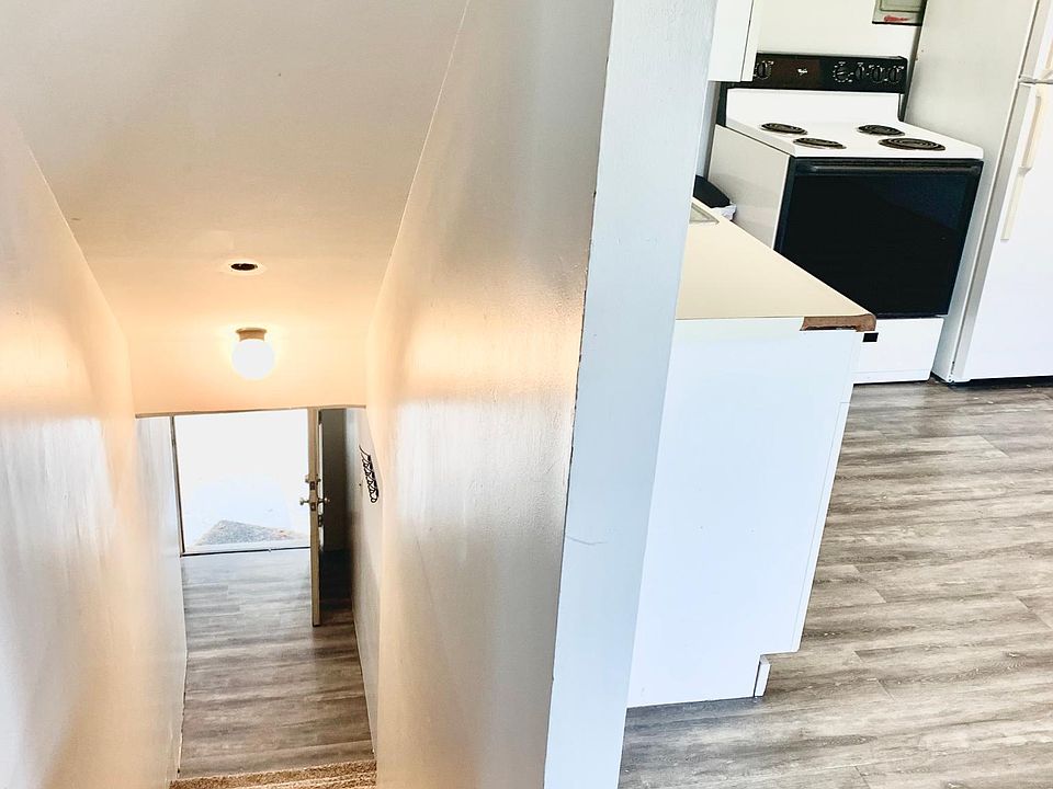 Stairway leading upstairs from outside & kitchen