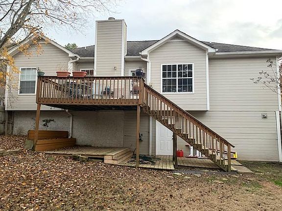 Back of house. Left end is a bedroom on top and below that bedroom is downstairs bedroom, Middle with chimney is the Great Room and below is the downstairs bath and window outset is the kitchen and the right end is the closet of the Master bedroom