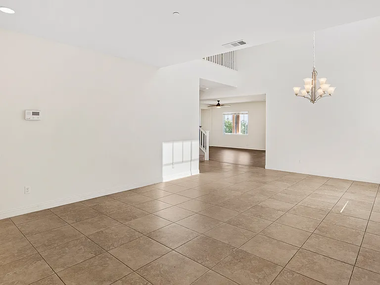 Formal Living/Dinning Room with Tile and High Ceiling to the Formal Family Room and Kitchen