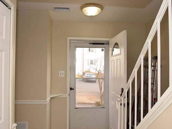 A view of the front door, to the right are stairs to the 2nd level