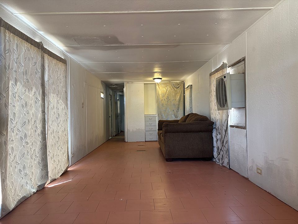 view from kitchen looking towards living room and bedroom (hall on left)