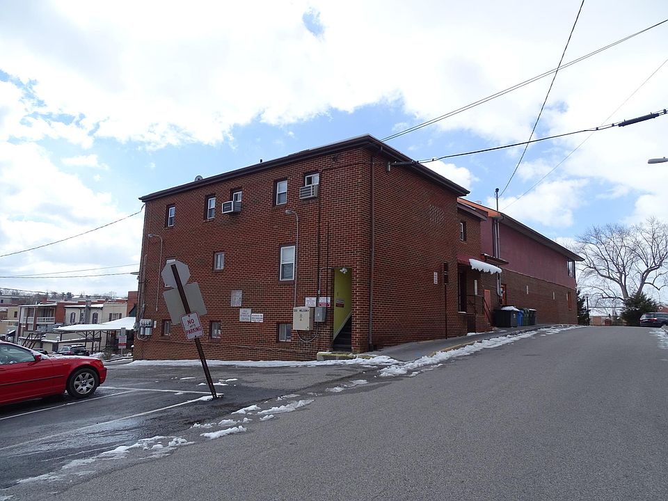 Standing on Wilson Ave looking at rear and side of building. Units are on top level.