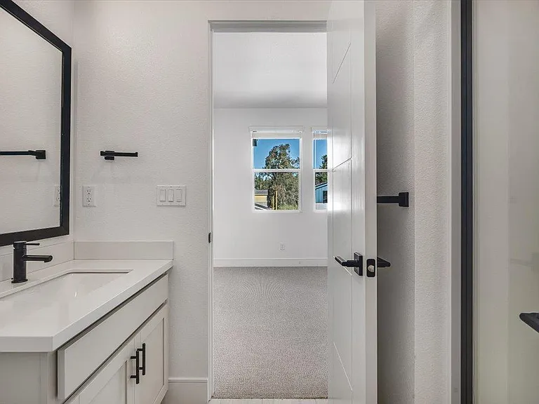 Bathroom has bedroom entrance and hallway/entry entrance for guests.