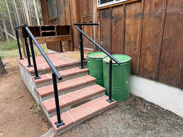 back porch and steps with bear-proof trash and recycling drums