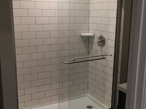 Downstairs 48 inch standing shower w/larger subway tiles