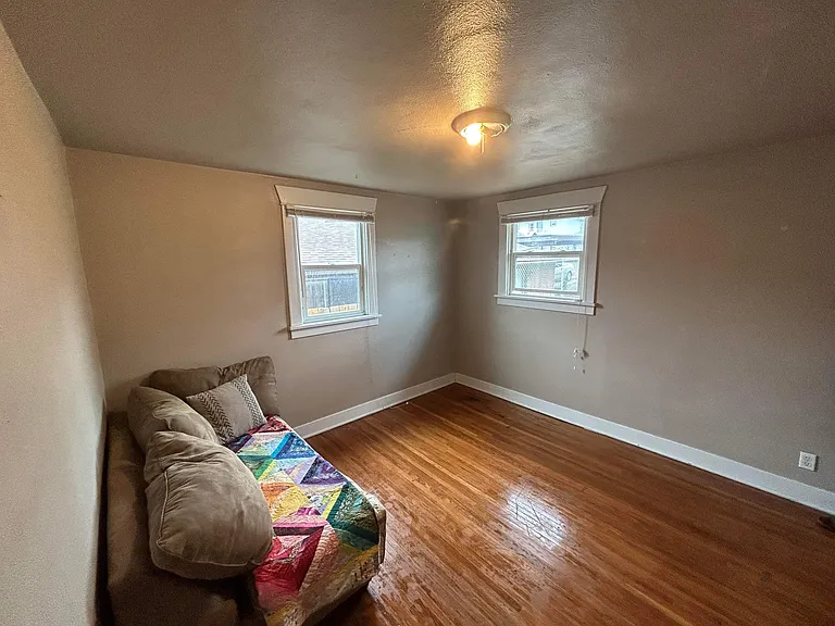 The back bedroom is similar in size to the front bedroom but is more private as it faces the backyard.