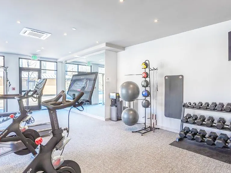 Fitness Center with Dumbbells and Peleton Bikes