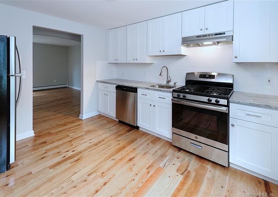 Kitchen with stainless steel appliances and granite countertops.