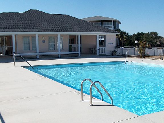 Private community pool with clubhouse across the street from the house.