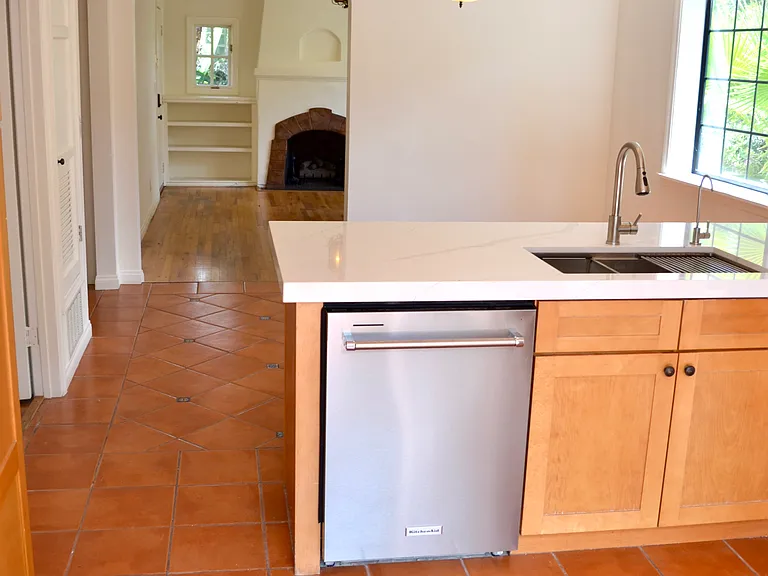 Kitchen opens to dining room and living room beyond.