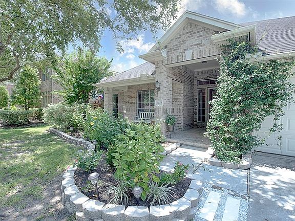 A closer view of the the gorgeous stone accented garden surrounding the front porch. Wonderfully inviting for your guests.