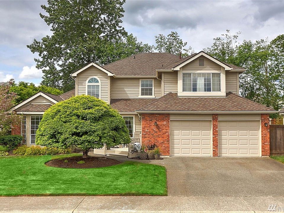 Welcome home to this beautifully maintained 4 bedroom, 3 bathroom home that offers an inviting deck at the entry to sit and relax or connect with neighbors. Greet guests in this dramatic, bright and airy foyer with open sightlines to the living and dining rooms. Enjoy working from the main floor office/den with views of the back yard.  This open kitchen and family room is the heart of this home, featuring a thoughtful kitchen design with plenty of counters and cabinets. Enjoy an over-sized island for prep and additional eat-in dining. Gather in the entertainment-sized family room with a gas fireplace and abundant windows that allow natural light to flow throughout the space. Extend your living space outdoors to a gorgeous covered deck featuring skylights, tongue & groove cedar ceiling and recessed lighting. Wired for TV, this space is perfect for movie nights  and year-round outdoor fun. The meticulously maintained yard is private with mature trees and raised garden beds. 