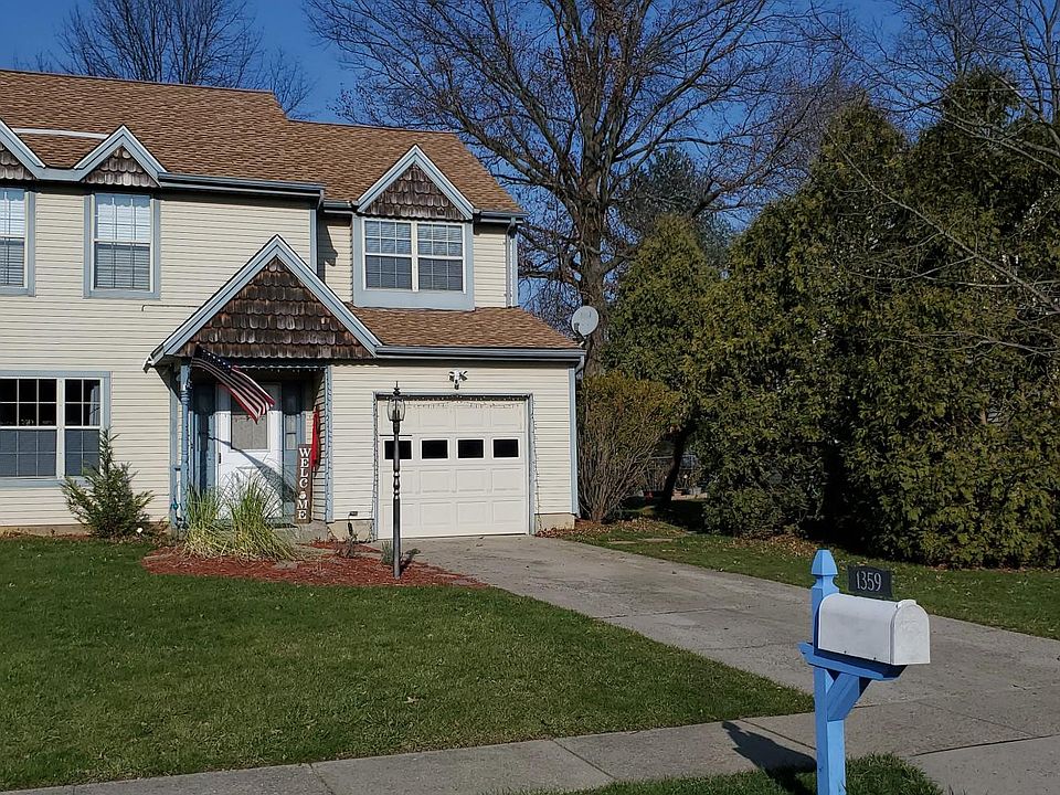 Front of home with Long Driveway and attached garage.