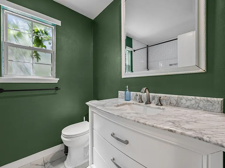 Downstairs bathroom with a recently renovated shower.