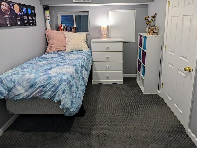 Basement common area opens into another room, frequently used as a third bedroom or home office.