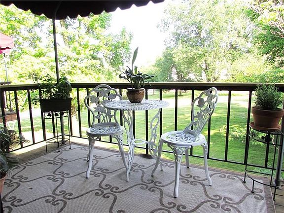A Sliding Door leads to the Covered Deck, where you can Relax & Enjoy the Green Views.