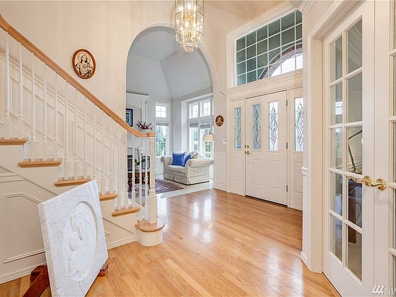 Another view of the entry area.  Notice the arched entry to the living room, the french-doored office/den, and the extensive windows providing soft ambient lighting.