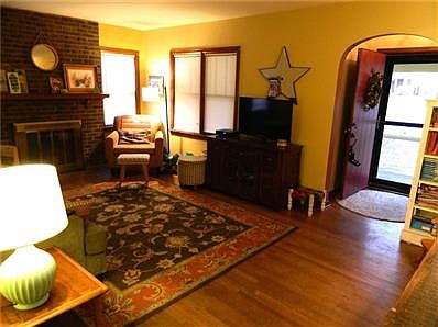 Enter into the cozy living room with hardwood floors and a working wood-burning fireplace!