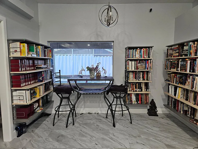Across from kitchen. Library overlooks Pool